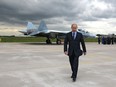 Russian Prime Minister Vladimir Putin walks after inspecting a new Russian fighter jet after its test flight in Zhukovksy, outside Moscow, Russia, on June 17, 2010.