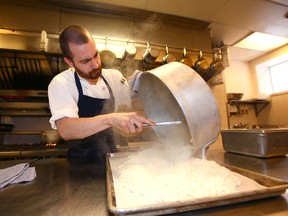 Trevor Stephenson prepares risotto for the lunch menu at Blink on Stephen Avenue Walk on Wednesday, Feb. 13, 2019. Restaurant owners, managers and staff are meeting to discuss challenges facing the industry.