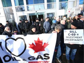 Oil and gas supporters gather in front of the National Energy Board in Calgary Friday, February 22, 2019. Jim Wells/Postmedia