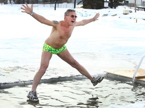 Gordon Szol hits the water during the annual fundraising event at the Special Olympics Law Enforcement Torch Relay Polar Plunge held at Arbour Lake in northwest Calgary on Saturday, February 23, 2019.