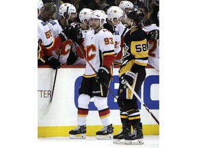 Calgary Flames forward Sam Bennett (93) celebrates his goal as he returns to the bench during the second period of an NHL hockey game against the Pittsburgh Penguins in Pittsburgh, Saturday, Feb. 16, 2019.