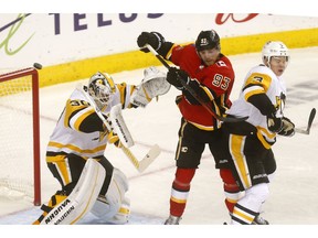 Pittsburgh Penguins goalie, Matt Murray battles Calgary Flames Sam Bennett in second period action at the Scotiabank Saddledome in Calgary on Thursday October 25, 2018. Darren Makowichuk/Postmedia