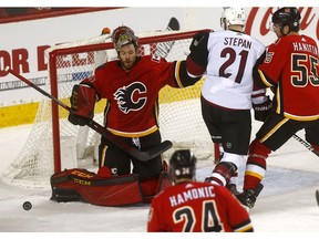 Calgary Flames goalie, Mike Smith loses his mask making a save on Arizona Coyotes in second period action at the Scotiabank Saddledome in Calgary on Monday February 18, 2019. Darren Makowichuk/Postmedia