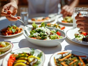 A group of people enjoy a vegan meal. Many older people have turned to veganism, noticing more energy and better health.