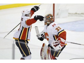 Calgary Flames goaltender David Rittich (33) and Calgary Flames left wing Matthew Tkachuk (19) celebrate defeating the Winnipeg Jets after NHL action in Winnipeg on Thursday, December 27, 2018. Instead of a celebratory pat, tap or fist bump after a win, Tkachuk and Rittich have been taking celebration to another level.THE CANADIAN PRESS/John Woods ORG XMIT: CPT145
