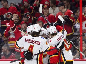 Flames fans celebrate as Calgary Flames centre Mikael Backlund (11) celebrates a first period goal with teammates NHL hockey action in Ottawa on Sunday, Feb. 24, 2019.