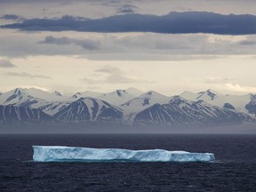 An iceberg floats past Bylot Island in the Canadian Arctic on July 24, 2017. Police say 30,000 litres of iceberg water has gone missing from a warehouse in Port Union, N.L.