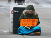 A homeless person panhandles in downtown Calgary in this file photo.