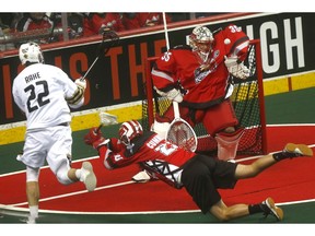 Calgary Roughnecks goalie Christian Del Bianco stops Vancouver Warriors' James Rahe in NLL action at the Scotiabank Saddledome in Calgary on Saturday February 2, 2019. Darren Makowichuk/Postmedia