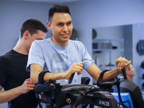 Dr. Richi Gill, in grey shirt, a Calgary doctor, takes part in physiotherapy in Calgary, Alta., Wednesday, Feb. 13, 2019. Dr. Richi Gill's life changed in an instant. The 38-year-old surgeon, who helped develop Calgary's bariatric surgery program, was involved in a freak accident on a boogie board during a family vacation in Hawaii one year ago. THE CANADIAN PRESS/Jeff McIntosh ORG XMIT: JMC301