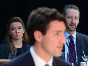 Chief of staff Katie Telford, left, and principal secretary Gerald Butts look on as Prime Minister Justin Trudeau delivers his opening remarks during the Meeting of First Ministers in Ottawa on Friday, Dec. 9, 2016. Trudeau's Liberal government and his hopes for re-election were rocked Monday by the resignation of his longtime friend and principal secretary Gerald Butts amid allegations that the Prime Minister's Office interfered to prevent a criminal prosecution of SNC-Lavalin.