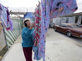 Mickie Subia gathers her laundry at her home in El Paso, Texas. Subia lives less than a block away from a border barrier that runs along the Texas-Mexico border.