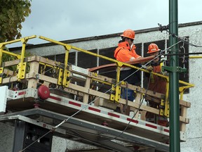 Workers repair power lines in Vancouver in this 2015 file photo.