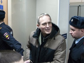 In this handout photo released by Courtesy of Jehovah's Witnesses, Dennis Christensen, who was leading the local Bible reading, is escorted from a court room in Oryol, Russia, Wednesday, Feb. 6, 2019. A regional court in western Russia on Wednesday sentenced a Danish Jehovah's Witness to six years in prison, in arguably the most severe crackdown on religious freedom in Russia in recent years. .