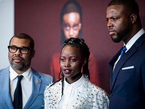 (FILES) In this file photo taken on March 20, 2019 (L-R) Director/writer Jordan Peele, actress Lupita Nyong'o and actor Winston Duke arrive for the New York premiere of "US" at the Museum of Modern Art in New York City. - With his new film "Us" blasting to an estimated $70.3 million opening in North American theaters in one of the best launches ever for a horror film, director Jordan Peele has done it again. Website BoxOfficeMojo called the film's three-day ticket sales "mind-blowing." The Universal production, which stars Lupita Nyong'o, Winston Duke and Elisabeth Moss in the story of a family that encounters horrifying versions of themselves, had the second-best launch of the year, trailing only blockbuster "Captain Marvel," according to industry watcher Exhibitor Relations. (Photo by Johannes EISELE / AFP)JOHANNES EISELE/AFP/Getty Images