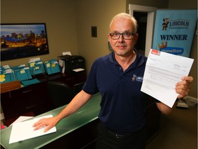 Fred Hamilton of Lincoln Exterior Renovations holds up his recent tax assessment notice on Oct. 24, 2018.