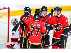 Calgary Flames Sam Bennett celebrates with teammates after scoring against the New Jersey Devils in NHL hockey at the Scotiabank Saddledome in Calgary on Tuesday, March 12, 2019. Al Charest/Postmedia