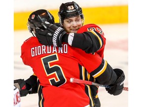 Calgary Flames Sam Bennett celebrates with teammate Mark Giordano after scoring against the New Jersey Devils in NHL hockey at the Scotiabank Saddledome in Calgary on Tuesday, March 12, 2019. Al Charest/Postmedia