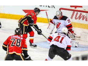 Calgary Flames star Johnny Gaudreau scores his third goal of the night on Mackenzie Blackwood of the New Jersey Devils during NHL hockey at the Scotiabank Saddledome in Calgary on Tuesday. Photo by Al Charest/Postmedia.