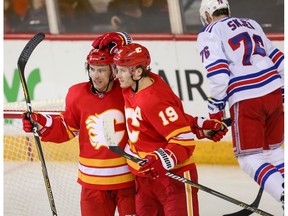 The Calgary Flames' Garnet Hathaway celebrates with teammate Matthew Tkachuk after scoring against the New York Rangers in NHL hockey at the Scotiabank Saddledome in Calgary on Friday, March 15, 2019. Al Charest/Postmedia