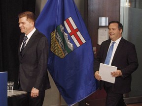 Former Wildrose leader Brian Jean, left, and former PC leader Jason Kenney walk in to a press conference to announce a unity deal between the two in Edmonton on Thursday, May 18, 2017.