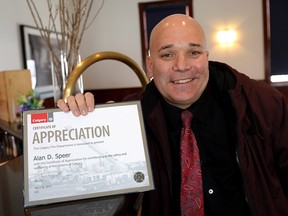 Calgary Transit driver Alan Speer with his appreciation award at the Calgary Fire Department's annual Beyond the Call recognition event on Wednesday, March 6, 2019.