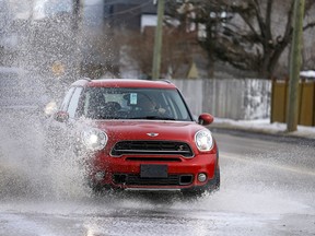 The warmer weather and thaw in Calgary has caused some major puddles along roads like this one on Kensington rd. near Crowchild Trail on Saturday, March 16, 2019.