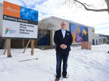 Jeff Wilson, board chair with the Foundations for the Future Academy, stands next to a government funding sign that has stood in front of the academy's high school in Montgomery since 2014. The school is filled with serious structural failures that have yet to be repaired. Wilson was photographed at the school on Thursday February 28, 2019.
