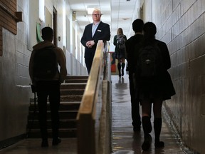 Jeff Wilson, board chair with the Foundations for the Future Academy, stands next to a government funding sign that has stood in front of the academy's high school in Montgomery since 2014.