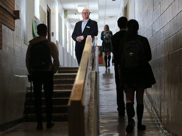 Jeff Wilson, board chair with the Foundations for the Future Academy, stands next to a government funding sign that has stood in front of the academy's high school in Montgomery since 2014. The school is filled with serious structural failures that have yet to be repaired. Wilson was photographed at the school on Thursday February 28, 2019.