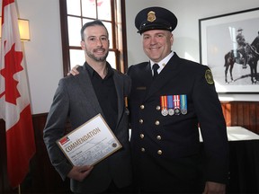 Vitor Sousa, left, receives a  commendation award at the Calgary Fire Department's annual Beyond the Call ceremony on Wednesday, March 6, 2019. Beside him is Brad McDonald, who nominated Sousa for the award.