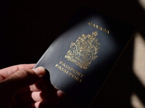A Canadian passport is displayed in Ottawa on July 23, 2015. International law does not require Canada to give citizenship to babies born on its soil, the federal government is telling the Supreme Court.