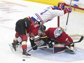 Les Canadiennes de Montreal's Hilary Knight collides with the Calgary goal under a challenge from Calgary Inferno's Kacey Bellamy and goaltender Alex Rigsby yesterday. The Inferno beat Les Canadiennes to win the Clarkson Cup (The Canadian Press)