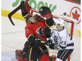 Flames Mark Jankowski (L) mixes it up in the crease with Kings Dustin Brown in front of goalie Mike Smith during NHL action between the Los Angeles Kings and the Calgary Flames in Calgary Friday, November 30, 2018. Jim Wells/Postmedia