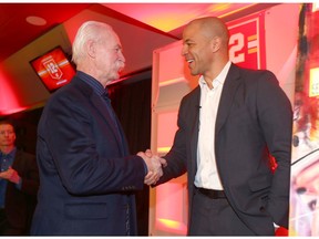 Lanny McDonald (L) and Jarome Iginla greet each other during a luncheon and media conference in Calgary at the Saddledome Friday, March 1, 2019. Iginla's jersey will be retired at a pre-game ceremony on Saturday night. Jim Wells/Postmedia