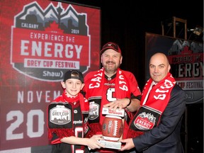 Cameron Zerk, 12 yrs, his father Randy Zerk and 2019 Grey Cup Festival Chair Mike Franco pose in Calgary on Thursday, March 7, 2019 as plans were released for the festival leading up the 107th Grey Cup game in November. Randy plans to attend his 36th Grey Cup game in Calgary with his son-which will be his third Grey Cup Game. Jim Wells/Postmedia