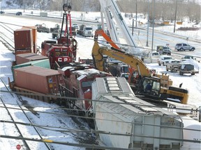 Canadian Pacific workers clean up following a train derailment near Ogden Rd and 50 Ave SE in Calgary on Saturday, March 9, 2019.