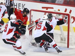 Flames forward Mark Jankowski jams home a first-period goal past Senators goalie Craig Anderson during NHL action between the Ottawa Senators and the Calgary Flames in Calgary on Thursday. Photo by Jim Wells/Postmedia.