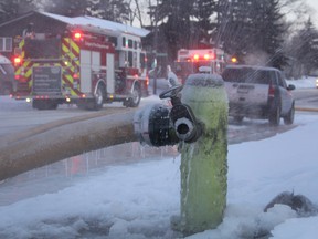 A cloud of water and ice crystals form around a fire hydrant on 33a Avenue S.E. as the Calgary Fire Department battles a blaze inside a one-story home in the Calgary community of Dover on Wednesday, March 6, 2019. (Ryan Rumbolt / Postmedia)