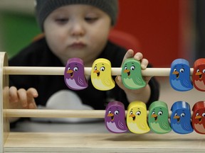 File photo: Max Braun, 11 months old, plays with bird blocks during an open house held at Kids & Company in the Edmonton Tower in downtown Edmonton, Alberta on Tuesday, Nov. 15, 2016.