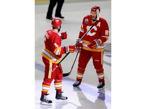Flames defenceman Robyn Regehr, right, celebrates with fellow blueliner Mark Giordano after Giordano scored the first goal of the game against the Vancouver Canucks in their season opener on Oct. 1, 2009 at the Saddledome. Postmedia file photo.