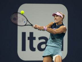 Angelique Kerber, of Germany, returns a shot to Bianca Andreescu, of Canada, during the Miami Open tennis tournament, Sunday March 24, 2019 in Miami Gardens, Fla.