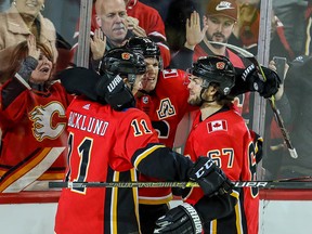 Calgary Flames Matthew Tkachuk celebrates with teammates after scoring one of his three goals against the Vegas Golden Knights at the Saddledome on Sunday, March 10, 2019.