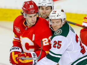 Flames centre Sean Monahan is covered in front of the Minnesota Wild net at the Saddledome in Calgary on March 2, 2019.