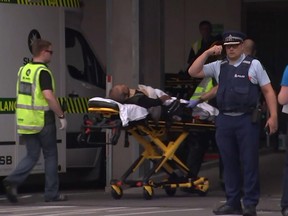 An image grab from TV New Zealand taken on March 15, 2019 shows a victim arriving at a hospital following the mosque shooting in Christchurch. At least one gunman who targeted crowded mosques in the New Zealand city of Christchurch killed a number of people, police said, with Prime Minister Jacinda Ardern describing the shooting as "one of New Zealand's darkest days".