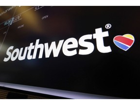 FILE - In this Monday, March 18, 2019, file photo, the logo for Southwest Airlines appears above a trading post on the floor of the New York Stock Exchange. The Federal Aviation Administration says a Southwest Airlines Boeing 737 Max jet made a safe emergency landing Tuesday, March 26, 2019, in Orlando, Fla., after experiencing an apparent engine problem.