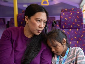 Vanessa Mae Rodel, 42, and her seven-year-old daughter Keana Nihinsa, travel by public bus from Castle Peak Immigration Centre, in Hong Kong on March 18, 2019.