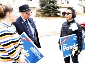 Calgary City Councillor Sean Chu speaks with Amy Schmidt while door knocking along Hawkcliff Way NW for UCP candidate Prasad Panda, one of several conservative candidates he plans on supporting. Wednesday, March 27, 2019. Brendan Miller/Postmedia