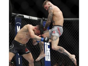 Cody Garbrandt lands a knee to Pedro Munhoz in a bantamweight mixed martial arts bout at UFC 235 on Saturday, March 2, 2019, in Las Vegas.