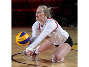 Calgary, AB. Feb. 22. 2018 -- U of C Dinos #12 Beth Vinnell prepares for a monster spike Thursday evening against Mount Royal University at the Jack Simpson Gymnasium during Canada West women's volleyball playoff action. The Dinos went on to defeat Mount Royal to take the first of a best of three series. ({David Moll} /Dino Digital Media) For {S} story by {}